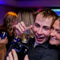 Two grads take a selfie smiling with their glasses